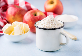 Cup of flour, butter, red apples and sugar
