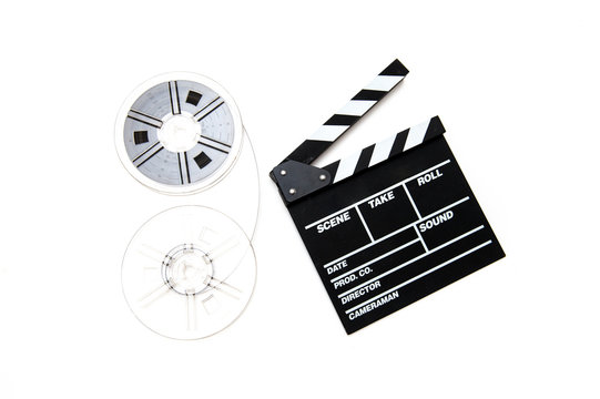 Vintage 8mm movie reels and clapper board white background