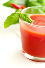 Tomato juice on white wooden table background