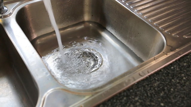 water flowing down the hole in kitchen sink