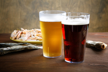 two glasses of beer with dried fish and crayfish