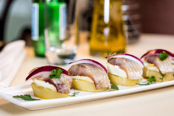 Restourant serving dish - pieces herring for snack