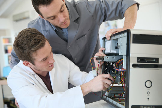 Young Adults Fixing Computer Hardware In Technology School