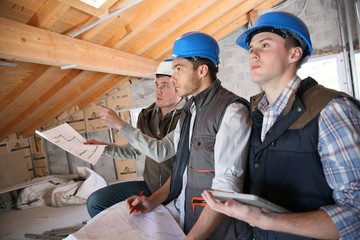 Construction manager with workers checking on site