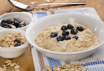 Bowl of oatmeal with fresh blueberries. Healthy traditional brea