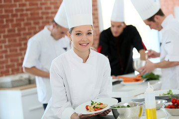 Portrait of student girl in cooking training course - obrazy, fototapety, plakaty