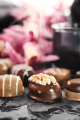 Chocolate pralines on abstract natural background