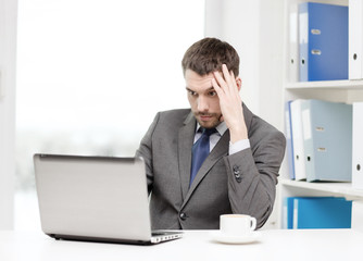 busy businessman with laptop and coffee