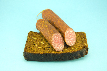 brown  bread and sausage on blue background