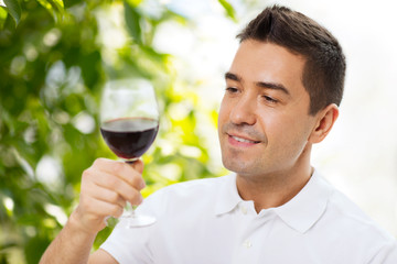 happy man drinking red wine from glass
