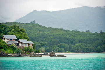 View of Seychelles coastline with a house in the forest