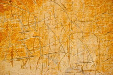 Scratched cement wall painted in orange