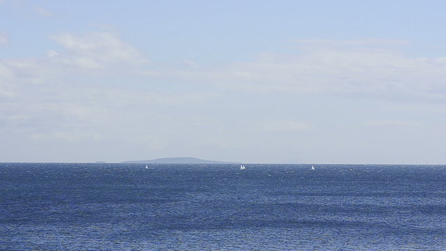 Yachts sailing in the blue sea