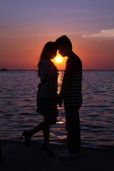 couple at sunset silhouette beach dawn 