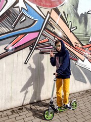 Fototapeta na wymiar cooler Junge vor Graffiti Wand
