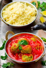 fish croquette in tomato sauce in a copper bowl