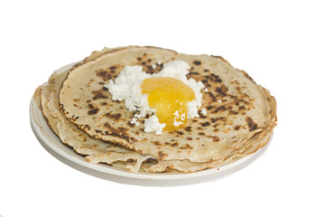 Pancakes and honey on the plate.