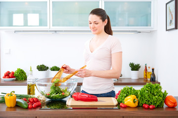 Young woman in the kitchen prepare salad XV