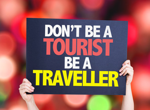 Don't be a Tourist Be a Traveller card with bokeh background