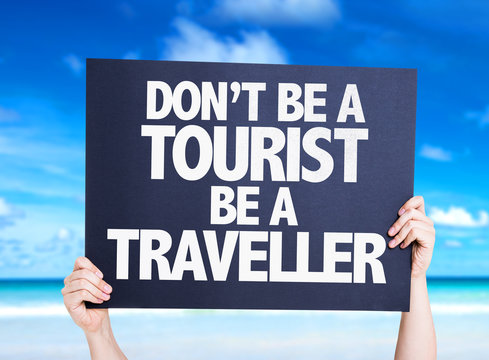 Don't be a Tourist Be a Traveller card with beach background
