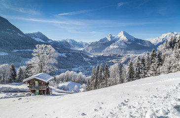 Idyllic winter landscape in the Alps with mountain chalet