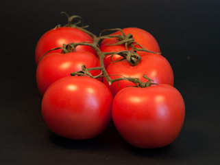 Tomatoes on black background