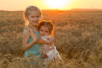 two child girls at the sunset field