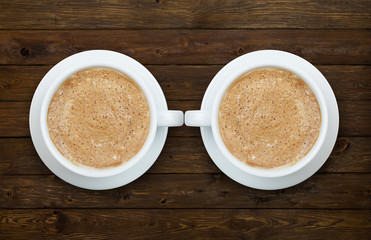 Two cups of coffee on the wooden table