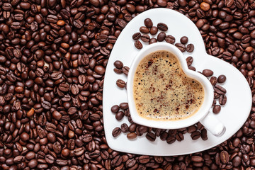 white coffee cup heart shaped with cappucino