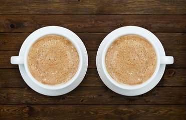 Two cups of coffee on the wooden table