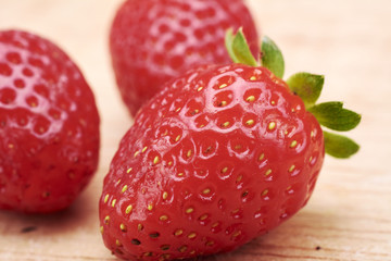 Strawberries red in wood background