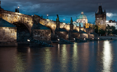 Fototapeta na wymiar Charles Bridge reflected in Vltava river in Prague
