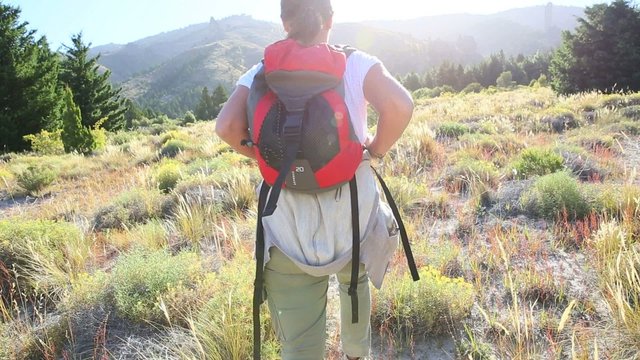 Woman backpacker walking by Limay river, North Patagonia