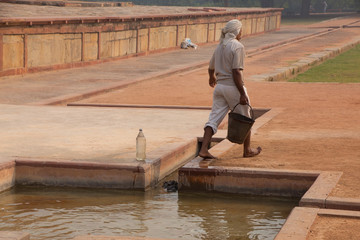 Indian man working at Humayun's Tomb complex, Delhi, India