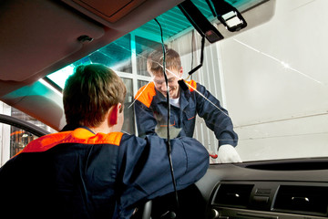 Two Real Mechanics working in Auto Repair Shop