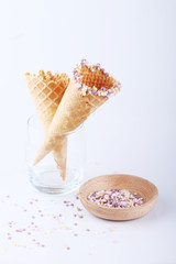 empty ice cream cones with colorful sprinkles