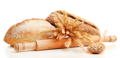 Fresh bread with wheat and sunflower seeds in wooden spoon