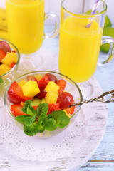 Fruit salad with mint and orange juice in glassware