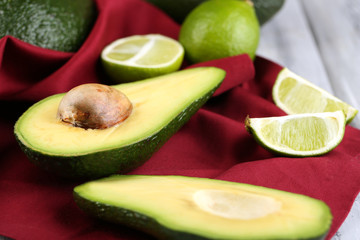 Avocado with limes on napkin close up