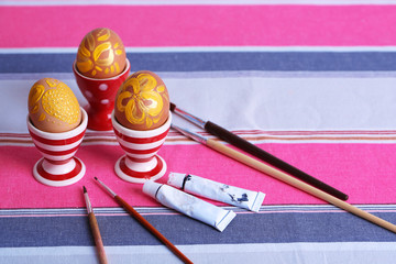 Painting Easter eggs on table close up