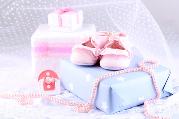 Pink baby boots with gift close-up