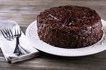 Delicious chocolate cake in plate with forks