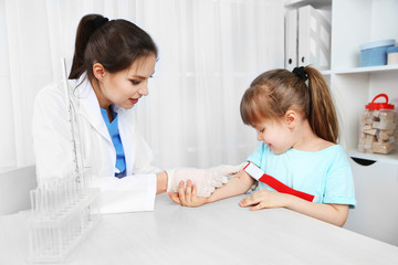 Fototapeta premium Nurse with syringe is taking blood for test in hospital