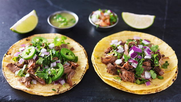 two authentic mexican tacos with barbacoa and carnitas