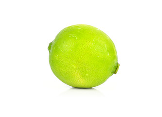 A whole fresh lime isolated on a white background