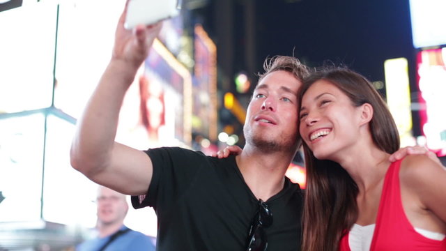 Dating young couple taking selfie in New York