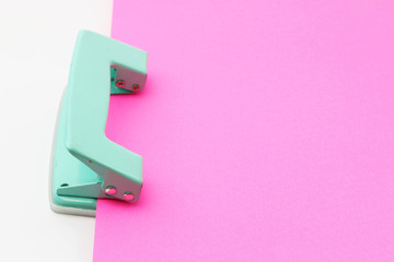 Hole puncher and blank paper on white