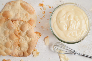 Custard cream on white vintage background. Preparation of sweet