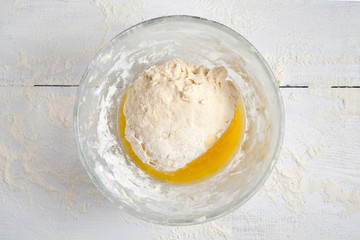 Dough mixed with melted butter in bowl