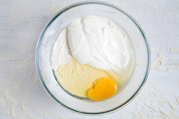 Dough preparation. Mixing ingredients for dough in bowl